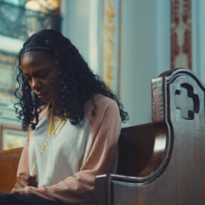 woman praying in church pew